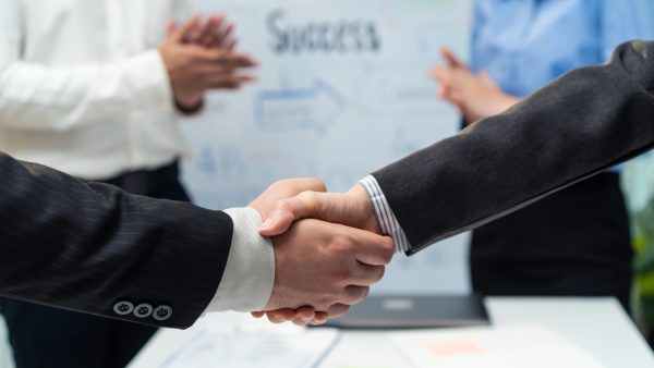 close-up-hands-of-business-people-handshake-after-2025-04-01-01-31-22-utc Close up hands of business people handshake after success negotiations. Employee worker team clap hand and enjoy partnership agreement, Business deal merger and acquisitionto in company meeting room.