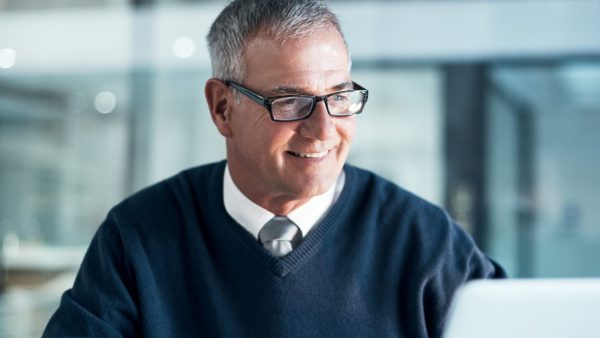 Results only reflect through hard work Shot of a mature businessman using a cellphone and laptop while working late in an office