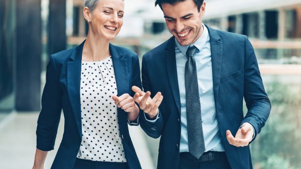 Happy business persons walking together Happy business persons walking together