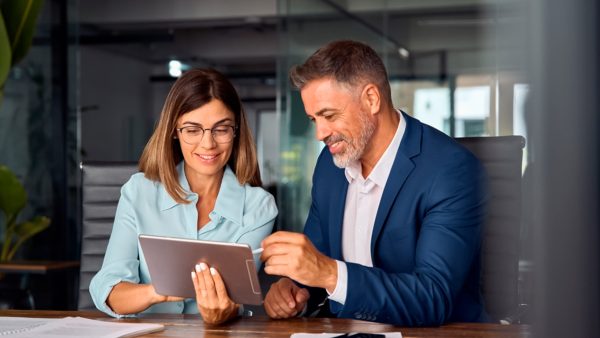 man-woman-are-looking-tablet-that-says-company man-woman-are-looking-tablet-that-says-company